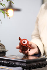 A small Kapu straight and wrinkled vermilion clay Yixing zisha pot with a Mengchen mark